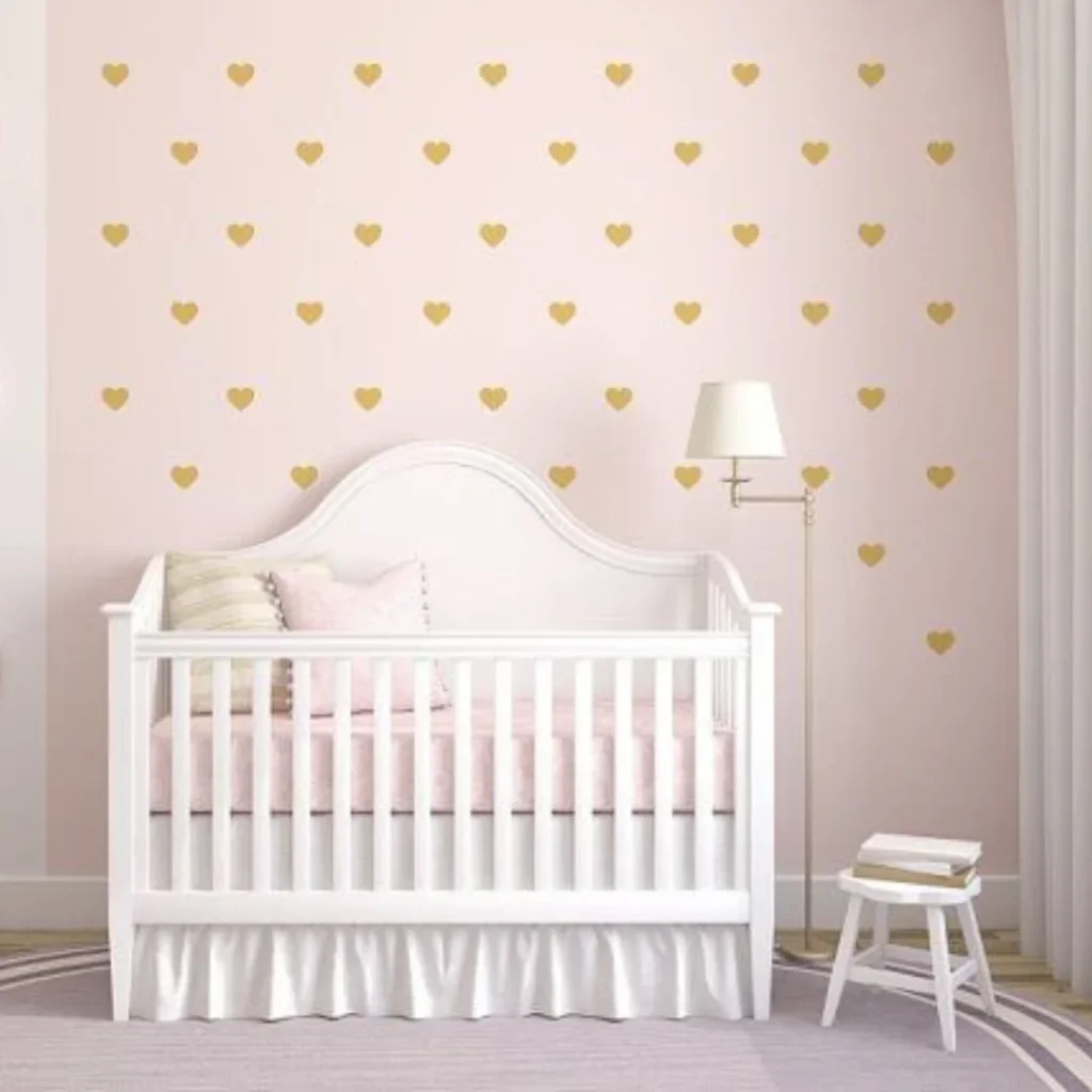 una habitación con pintura rosa y stickers de corazones en la pared